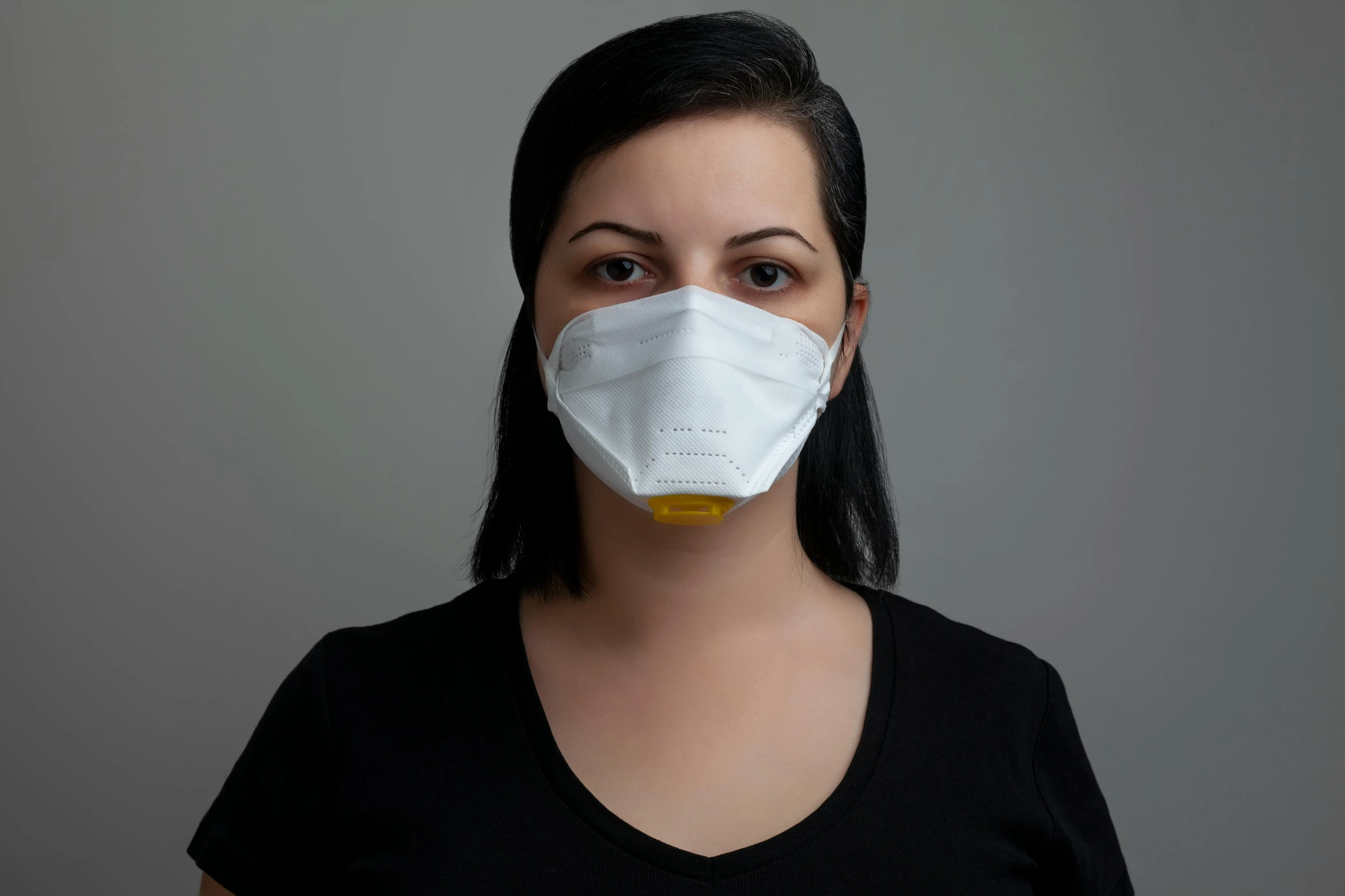 a woman in a black shirt is wearing a white mask, yellow, portrait n - 9, flat, australian