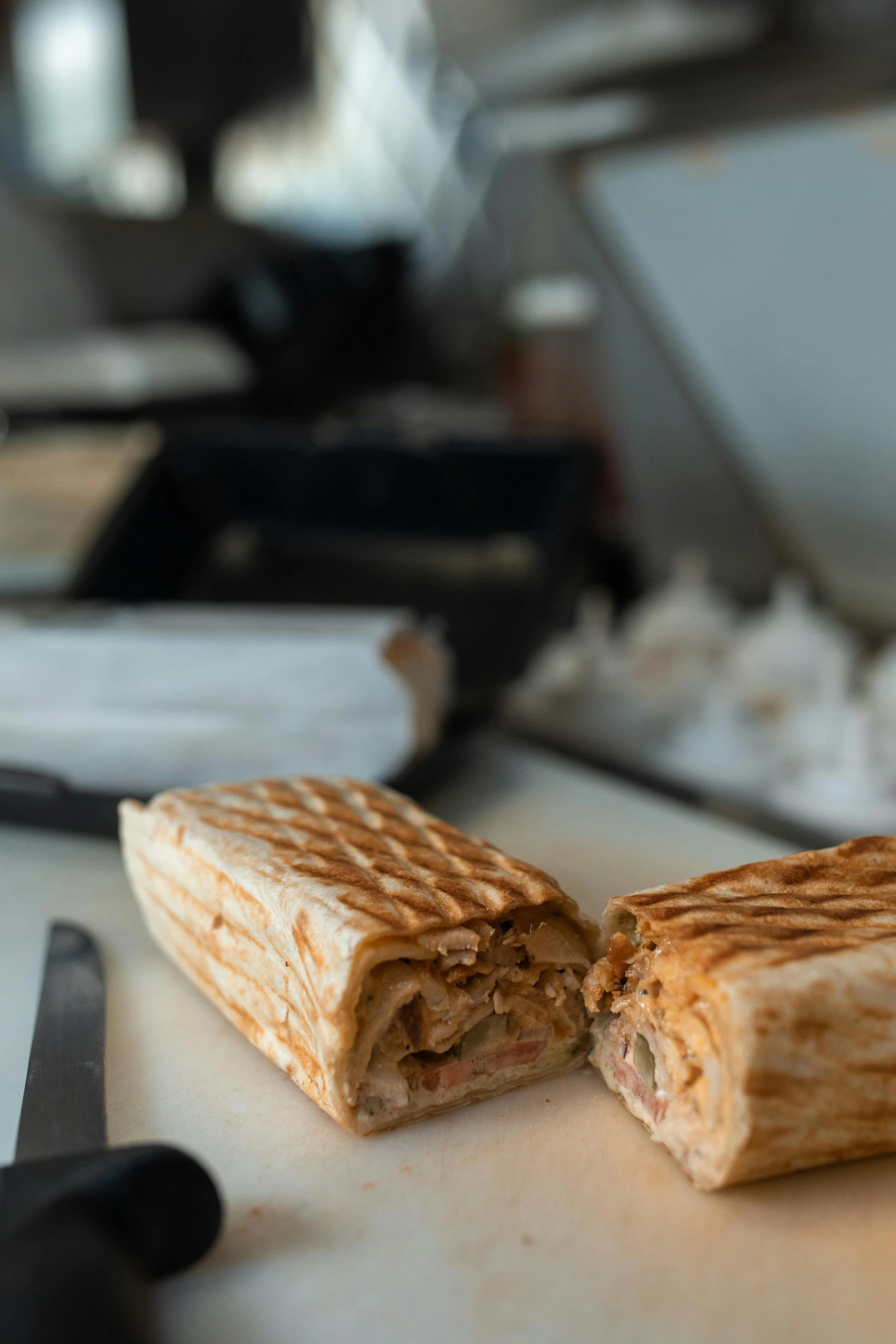 a cut in half sandwich sitting on top of a cutting board, a picture, unsplash, kebab, wafflehouse, panoramic shot, greek ameera al taweel