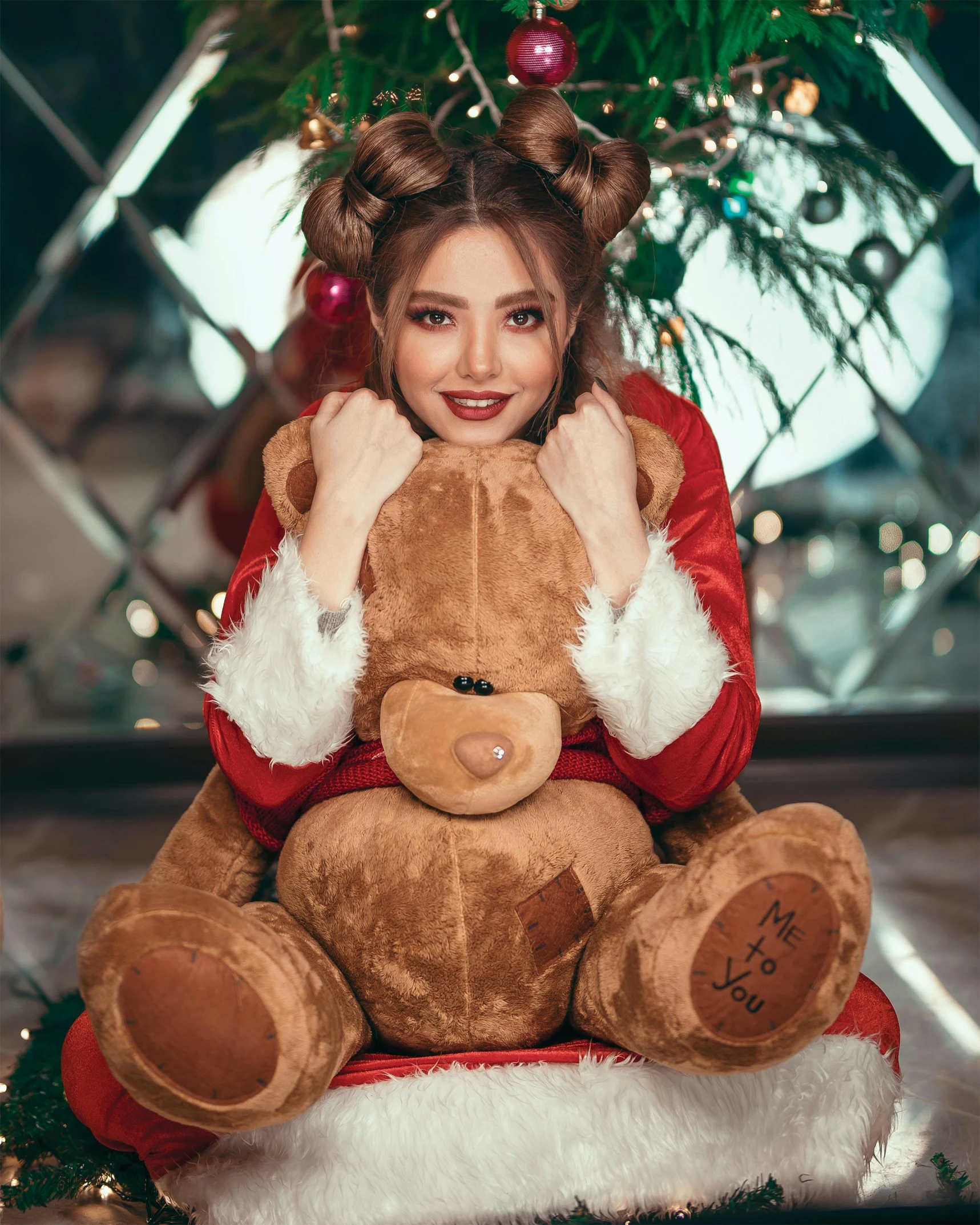 a woman sitting in front of a christmas tree holding a teddy bear, by Julia Pishtar, pexels contest winner, brown hair in two buns, young beautiful amouranth, v ray, santa
