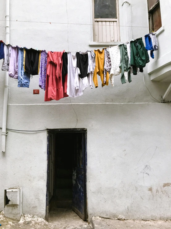 a building with clothes hanging out to dry, inspired by Zhang Kechun, unsplash, arte povera, in a small prison cell, promo image, naples, profile image