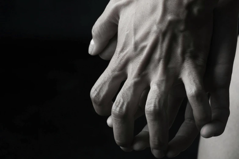 a black and white photo of a person's hands, unsplash, hyperrealism, bulging veins, paul barson, painful, intertwined