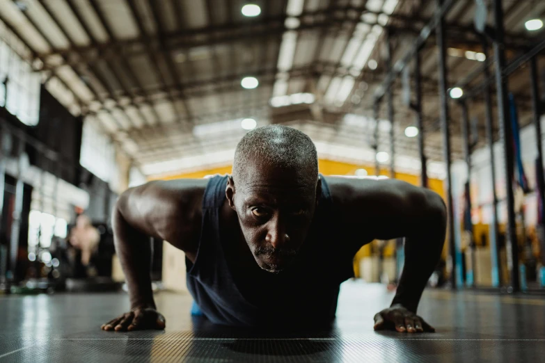 a man doing push ups in a gym, a portrait, by Will Ellis, pexels contest winner, emmanuel shiru, aged 4 0, background image, avatar image