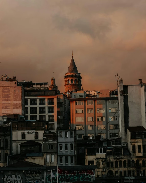 a group of buildings with a clock tower in the background, pexels contest winner, overcast dusk, the fall of constantinople, lgbtq, background image