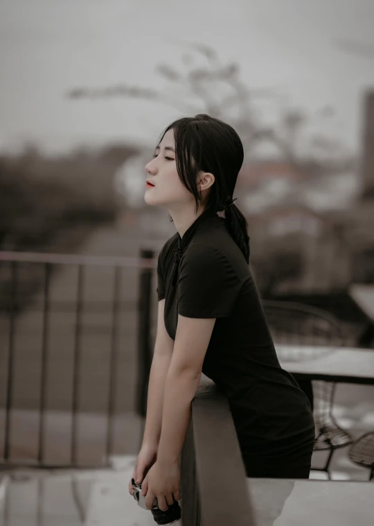 a woman sitting on a bench looking off into the distance, by Yosa Buson, pexels contest winner, realism, wearing black tshirt, 🤤 girl portrait, ☁🌪🌙👩🏾, elegant profile pose