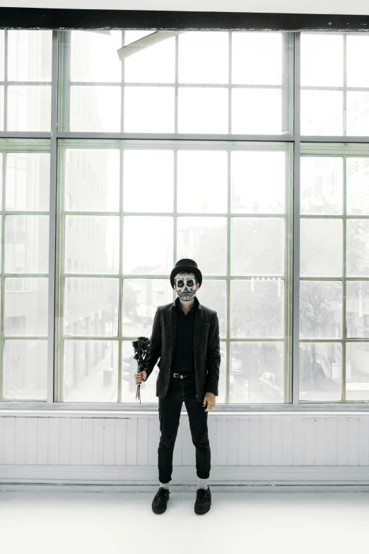 a man wearing a mask standing in front of a window, inspired by John Carpenter, unsplash, vanitas, full body with costume, sarah andersen, instagram picture, cosplayer