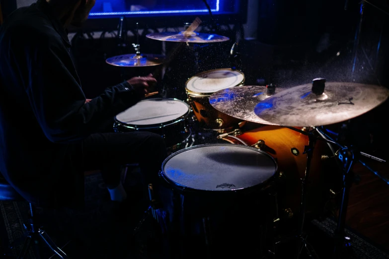 a man sitting in front of a drum set, zoomed in shots, avatar image, cinematic footage, high quality picture