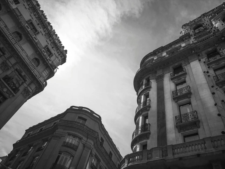 a couple of tall buildings next to each other, a black and white photo, unsplash, neoclassicism, barcelona, low angle fisheye view, featured, photographic print