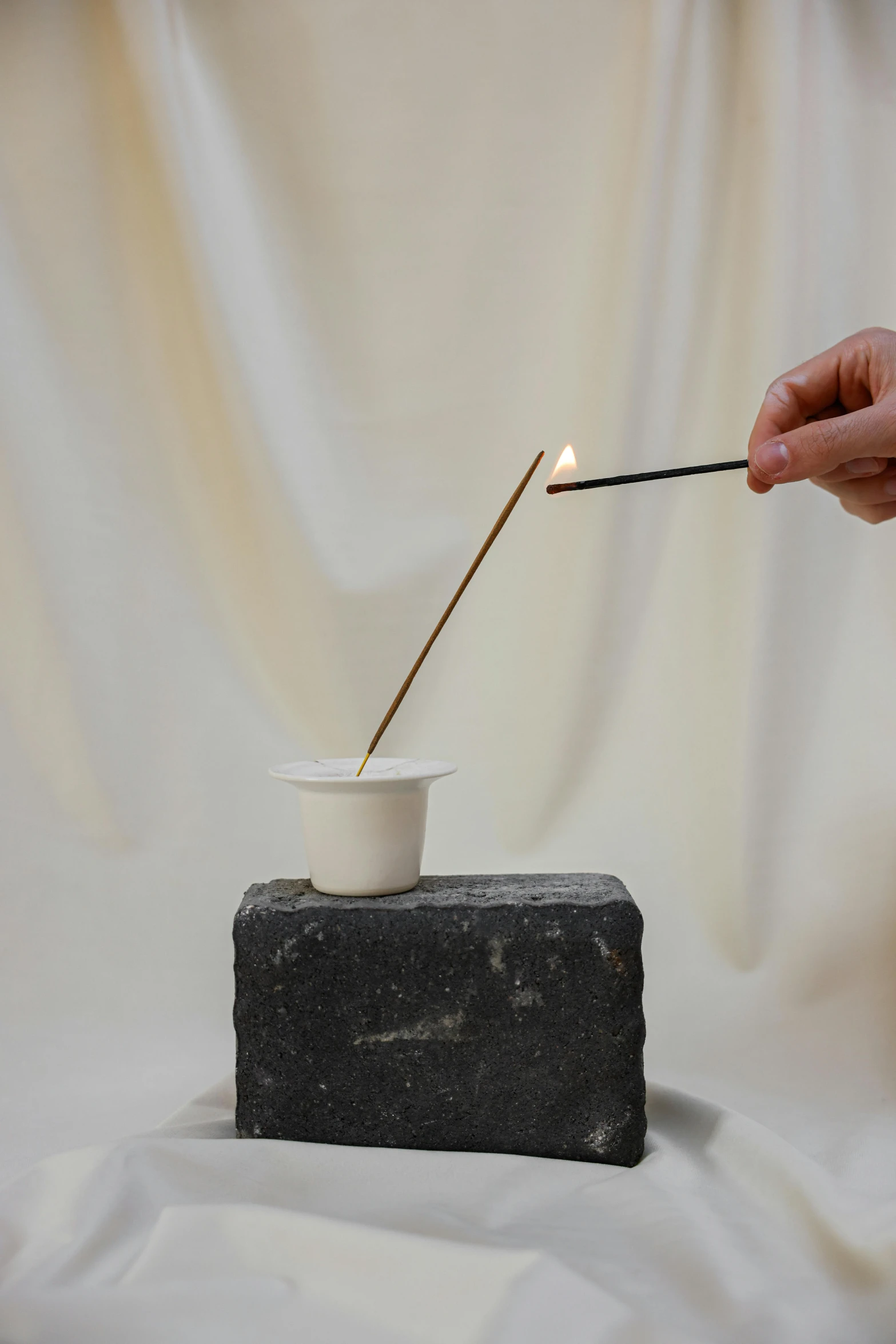a person lighting a match with a matchstick, a marble sculpture, inspired by Hendrik Gerritsz Pot, soft white rubber, tall, lofi, slate