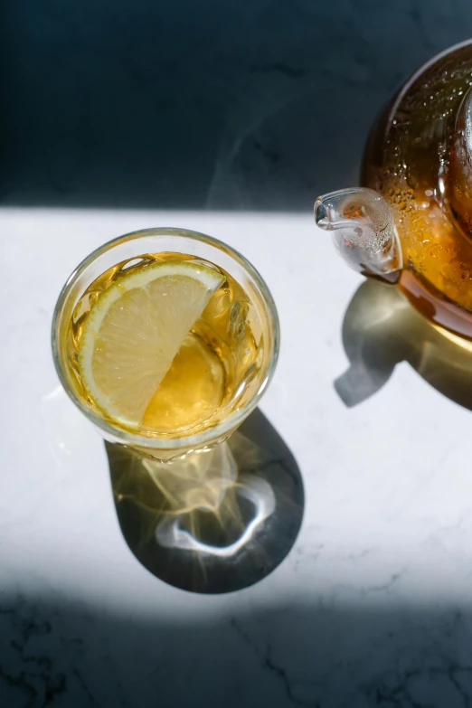 a bowl of donuts next to a glass of tea, a still life, by Carey Morris, trending on unsplash, renaissance, iced tea glass, with lemon skin texture, directional sunlight skewed shot, teapot : 1