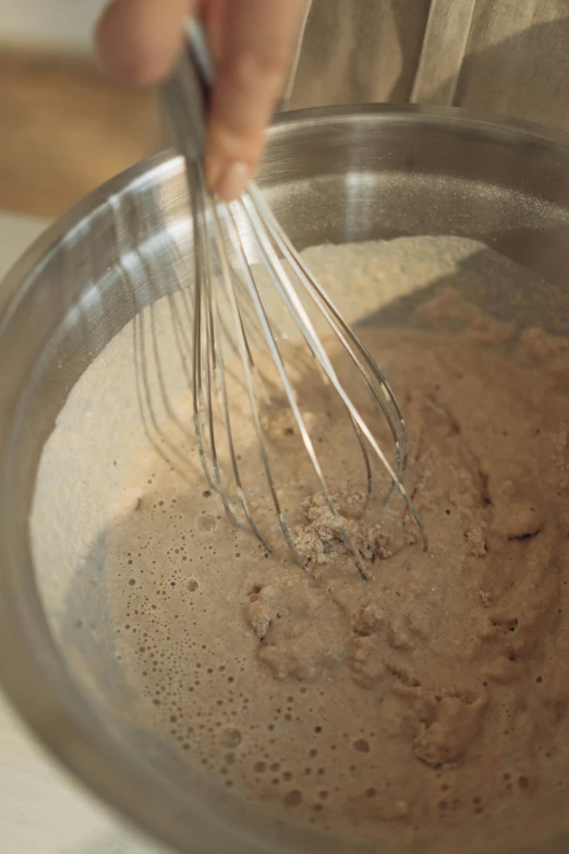 a person whisking a mixture in a bowl, muted browns, promo image, kek, super close up shot