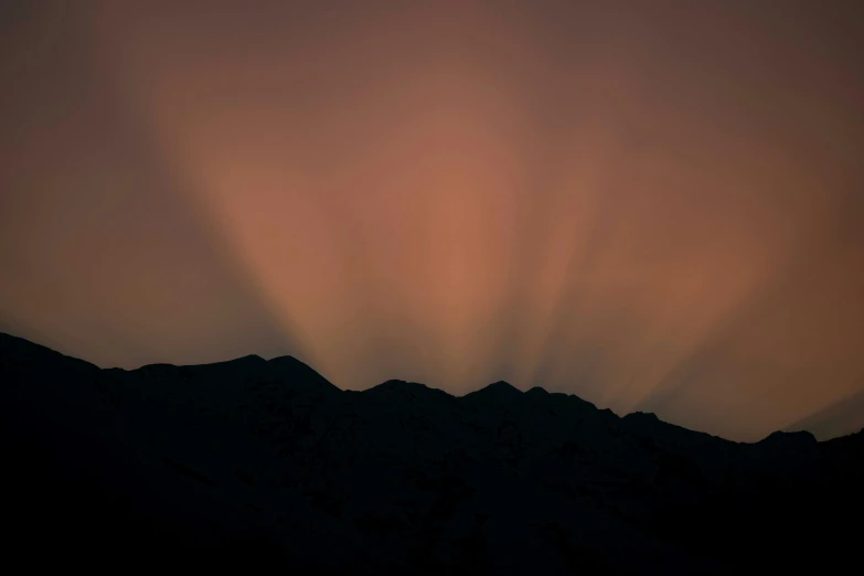 the sun shines through the clouds over the mountains, by Peter Churcher, pexels contest winner, tonalism, light refractions, (night), tyndall rays, pink sunlight