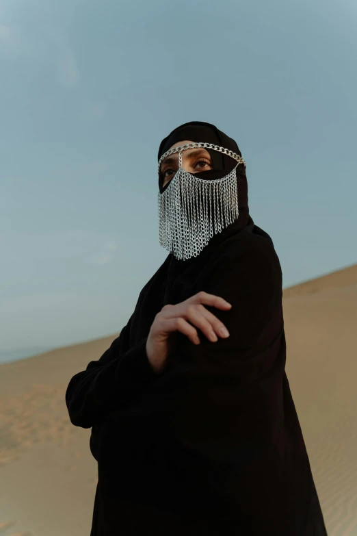 a person standing in the middle of a desert, an album cover, inspired by Hedi Xandt, trending on pexels, ski masks, burka, chainmail, (night)