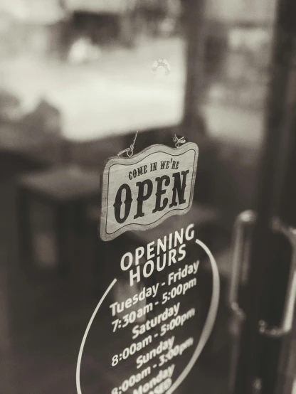a black and white photo of an open sign, pexels, happening, small hipster coffee shop, sepia photography, looking outside, order
