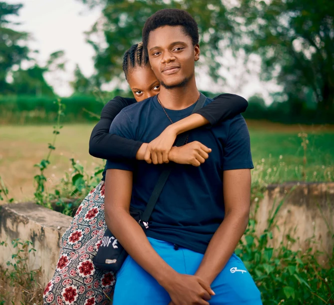 a man and a woman sitting next to each other, an album cover, by Chinwe Chukwuogo-Roy, pexels, teenage boy, embracing, 15081959 21121991 01012000 4k, fatherly