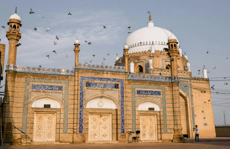 a large building with a lot of birds flying around it, by Riza Abbasi, dome, shrines, exterior photo, profile image