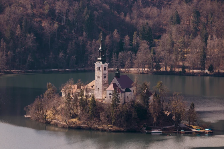 a church on an island in the middle of a lake, pexels contest winner, renaissance, muted colors. ue 5, helicopter view, 1940s photo, slovenian