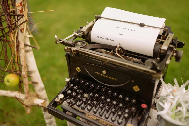 an old typewriter sitting on top of a table, by Romain brook, unsplash, private press, reading under a tree, wedding, 15081959 21121991 01012000 4k, high angle close up shot