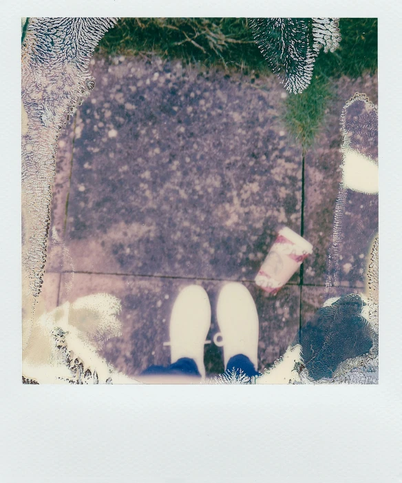 a pair of white shoes sitting on top of a sidewalk, a polaroid photo, milk puddles, bleached colours, in garden, still film