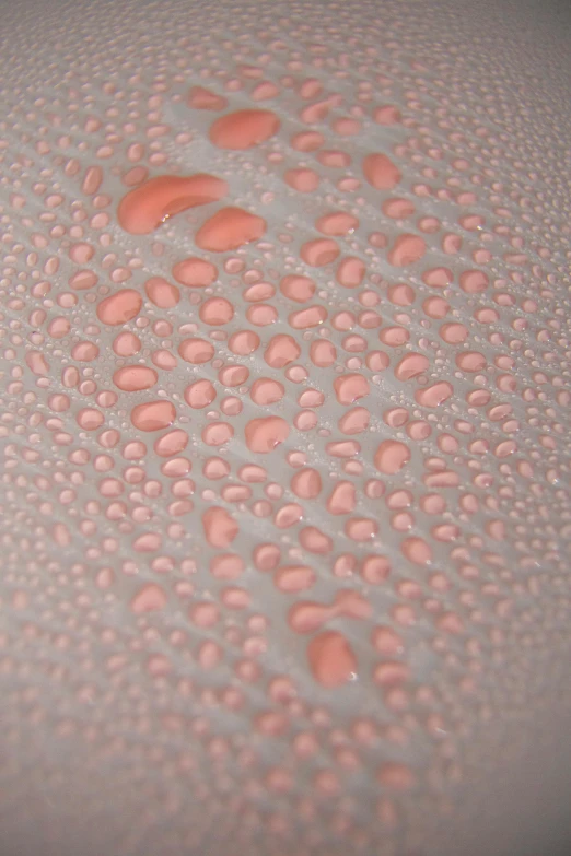 a close up of water droplets on a surface, an ultrafine detailed painting, inspired by Lucio Fontana, unsplash, smooth pink skin, organic ceramic fractal forms, bubble bath, silicone skin