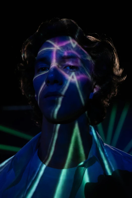 a man that is standing in the dark, an album cover, trending on pexels, holography, green glowing cracks on face, diego fernandez, blue and purle lighting, stranger things vecna