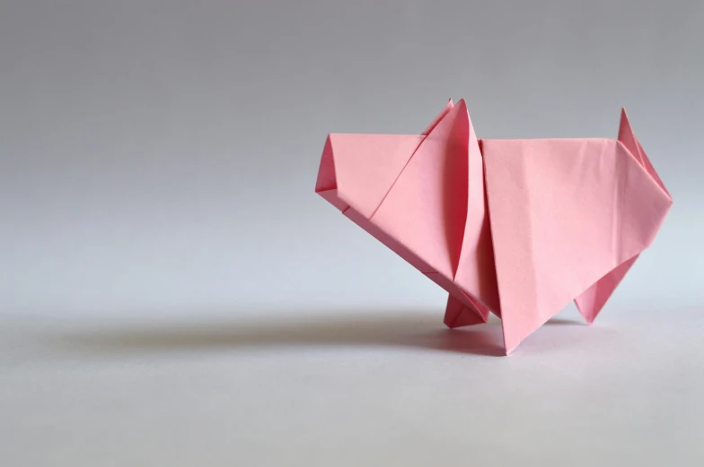 a pink origami elephant sitting on top of a white surface, trending on unsplash, mingei, a pig, louis kahn, ignant, portrait of a small