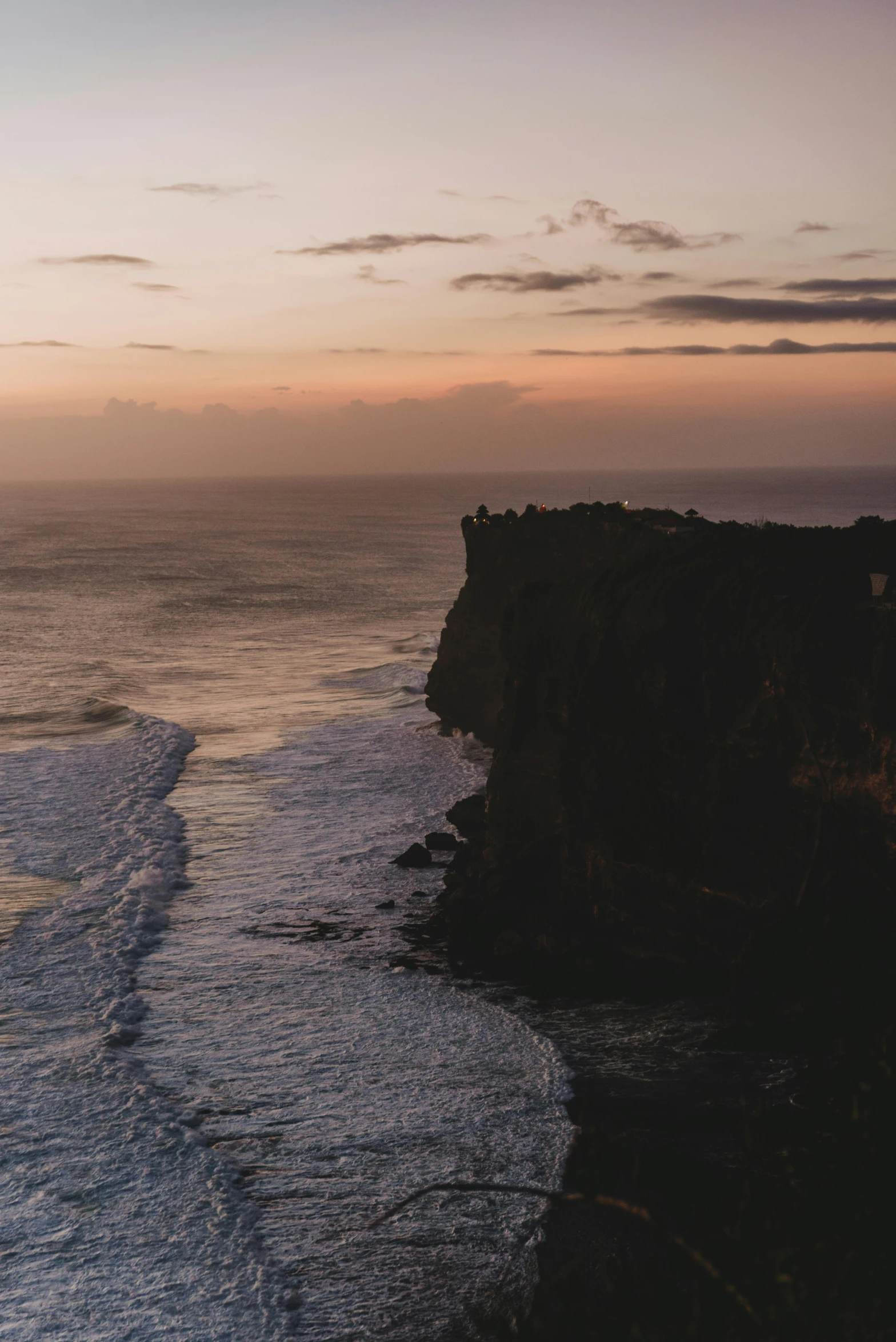 a large body of water next to a cliff, pexels contest winner, in a sunset haze, ocean cliff view, aerial footage, australia