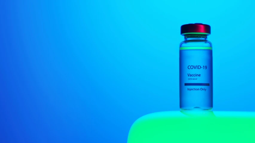 a bottle of water sitting on top of a table, a picture, visual art, coronavirus, gradient white blue green, holding syringe, red and blue neon