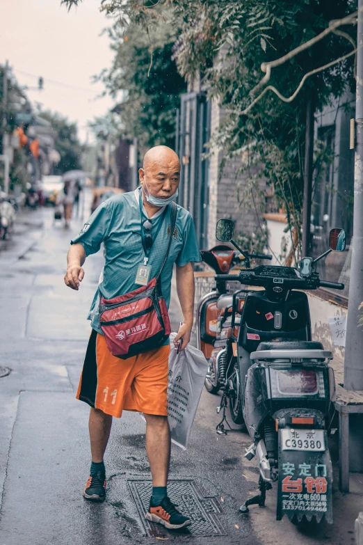 a man walking down the street in the rain, inspired by Steve McCurry, pexels contest winner, overalls and a white beard, chinese woman, carrying a saddle bag, wearing an orange t-shirt