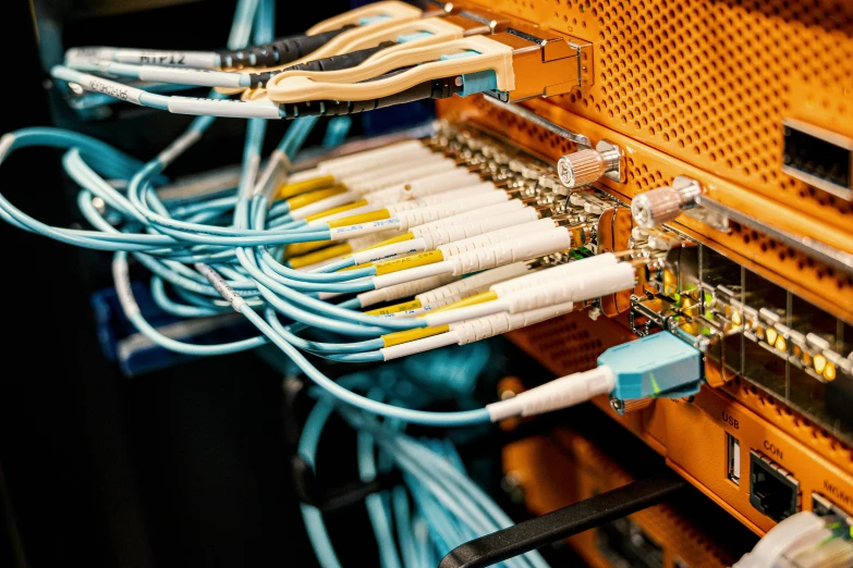 a bunch of wires that are connected to a computer, by Daniel Lieske, shutterstock, blue and orange lighting, server, instagram post, radio equipment