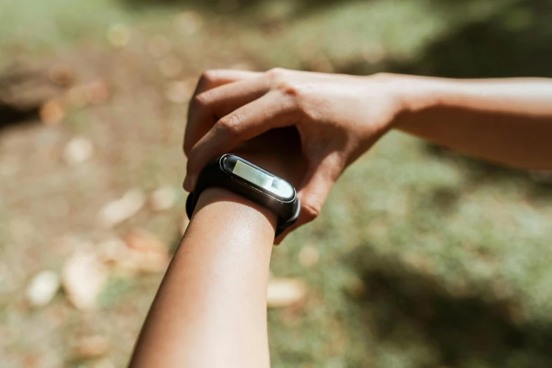 a close up of a person holding a cell phone, walking in a forest, wearing a watch, profile image, oh the places you'll go