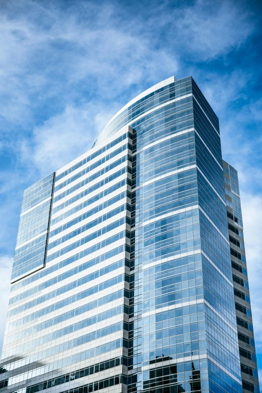 a very tall building with a lot of windows, by Randall Schmit, unsplash, blue and clear sky, capital plaza, slide show, seattle