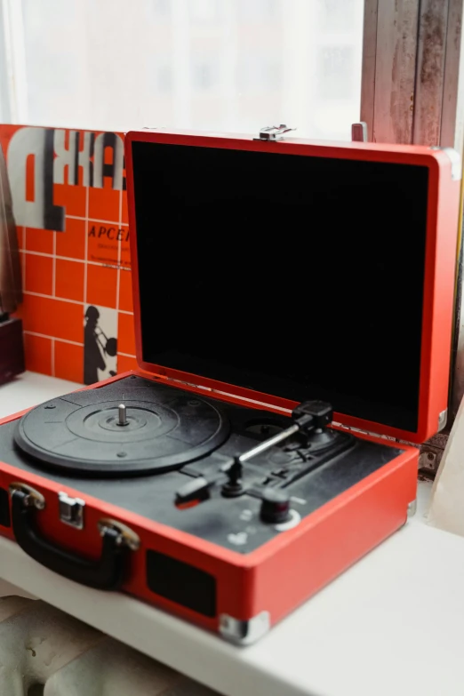 a record player sitting on top of a table next to a window, red theme, detailed product image, opening shot, vhsrip