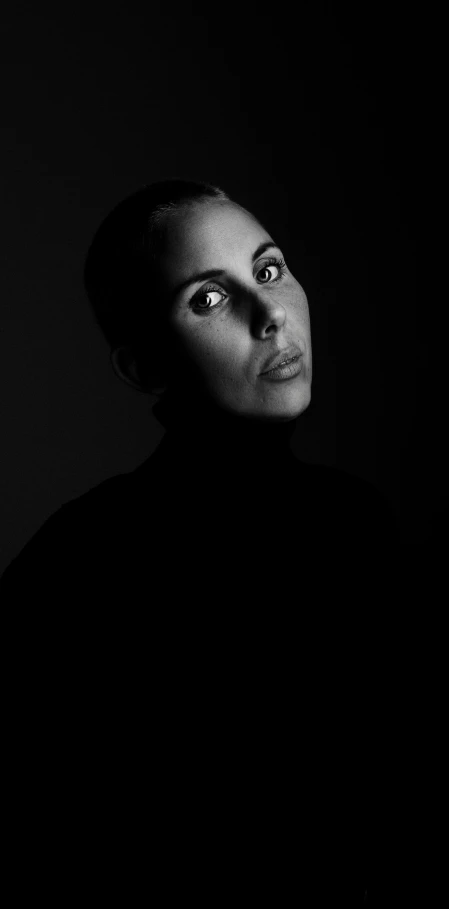 a black and white photo of a woman in the dark, a black and white photo, inspired by Yousuf Karsh, minimalism, large dark eyes, 15081959 21121991 01012000 4k, black main color, profile picture