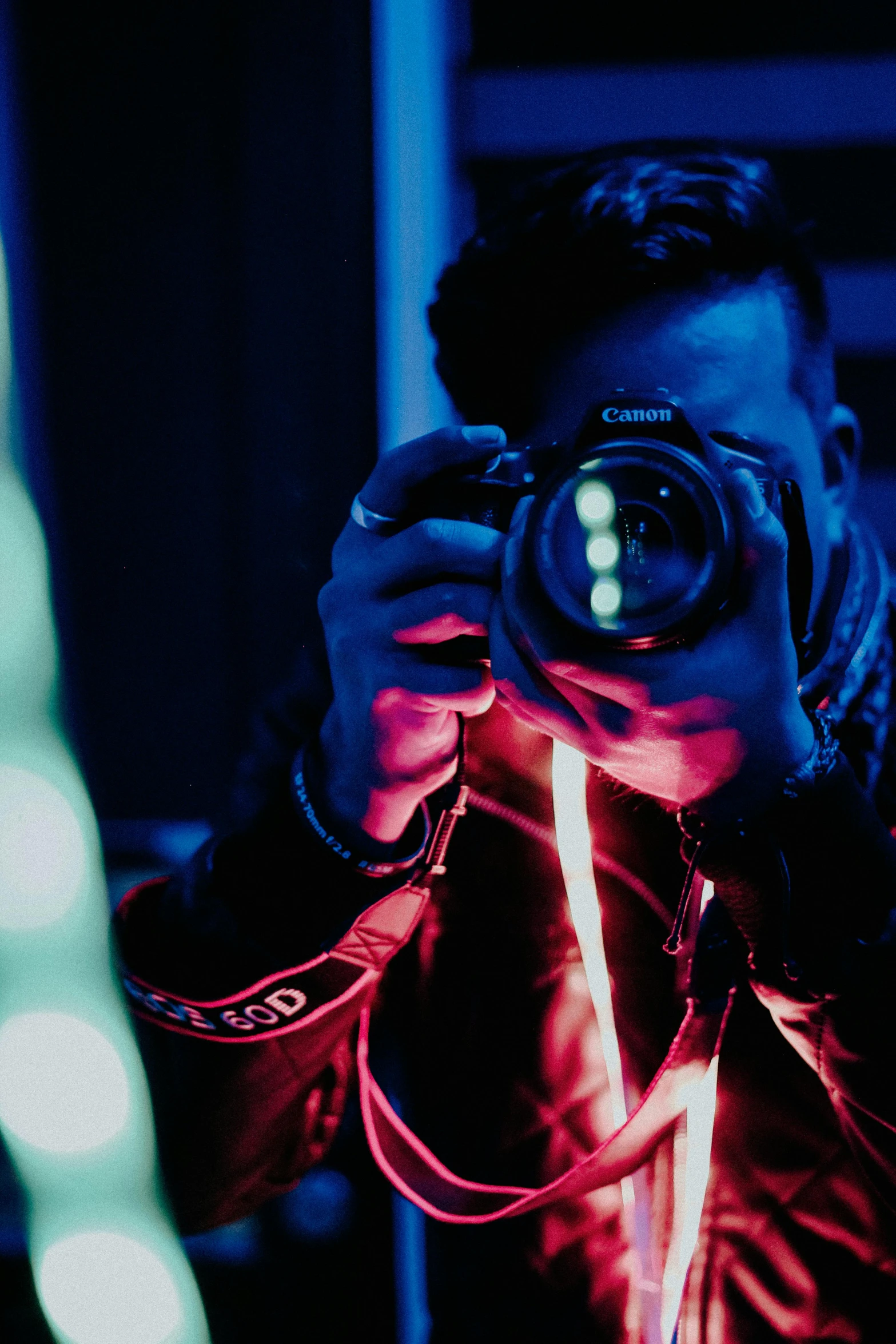 a man taking a picture of himself with a camera, inspired by Elsa Bleda, pexels contest winner, red and blue black light, nightlife, profile image, posing for a picture