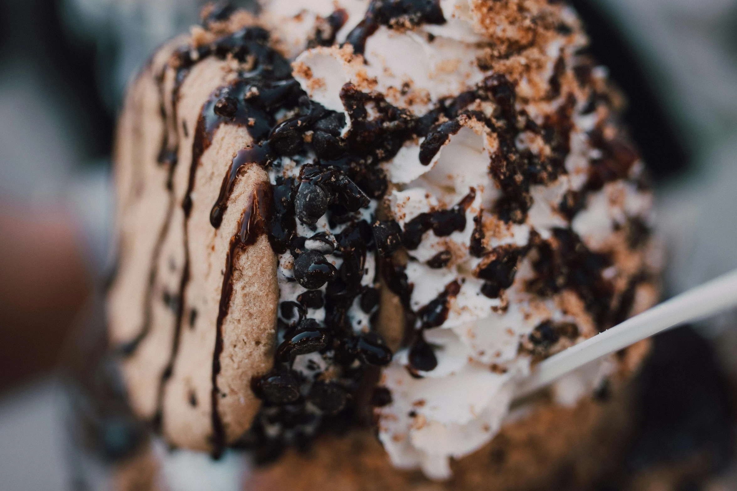 a close up of a dessert on a plate, trending on pexels, milkshake, black and brown, fan favorite, background image