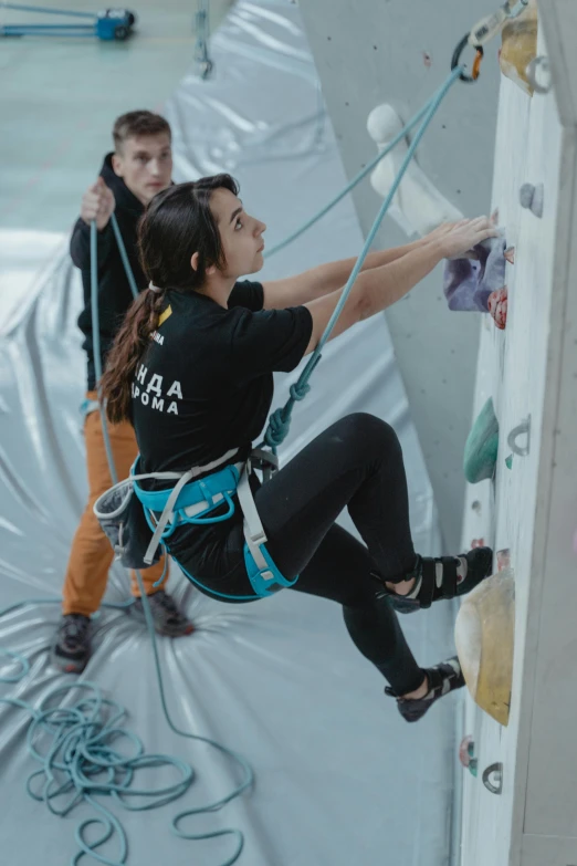 a man and a woman on a climbing wall, by Emma Andijewska, instagram, gutai group, banner, low quality photo, ana de la reguera portrait, female ascending