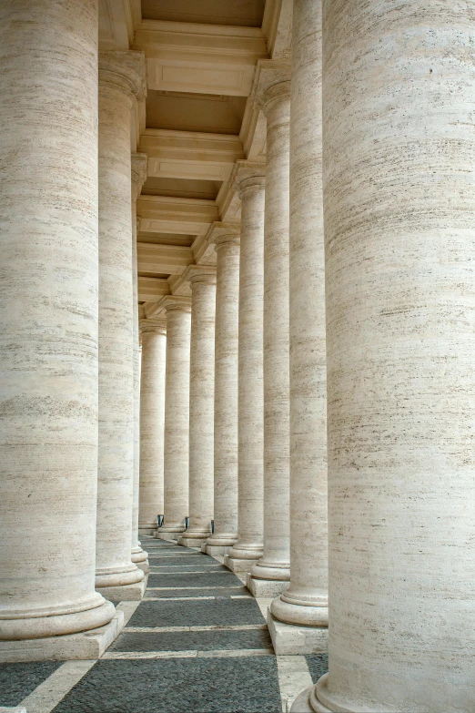 a long row of white pillars next to each other, a marble sculpture, inspired by Piero della Francesca, trending on unsplash, neoclassicism, sandstone, john paul ii, brown, made of marble