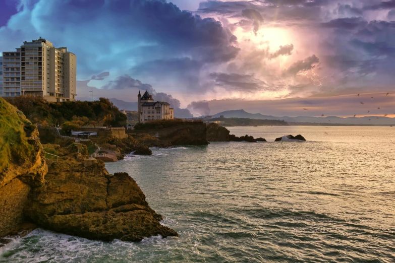 a large body of water next to a cliff, a matte painting, pexels contest winner, renaissance, light house, sunset with cloudy skies, la nouvelle vague, at the seaside