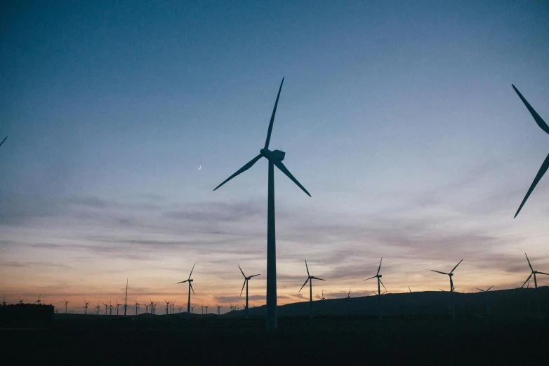 a group of wind turbines sitting on top of a field, pexels contest winner, at twilight, sustainable materials, thumbnail, unsplash photography