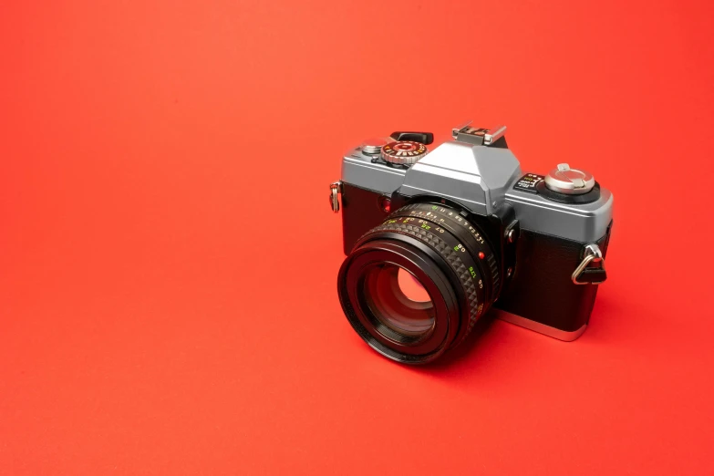 a camera sitting on top of a red surface, a picture, 80s photo, high-quality dslr photo”