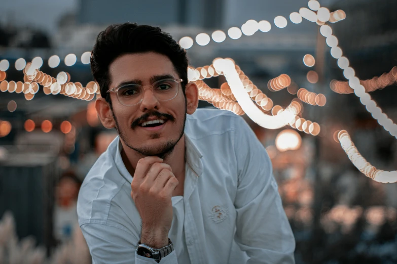 a man in a white shirt posing for a picture, pexels contest winner, unibrow, dazzling lights, mohamed chahin style, spectacled