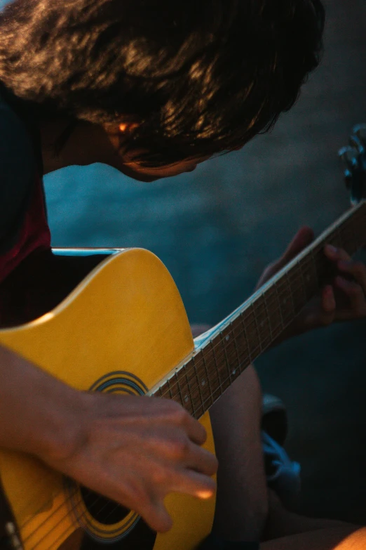 a close up of a person playing a guitar, pexels contest winner, paul barson, profile pic, multiple stories, uploaded