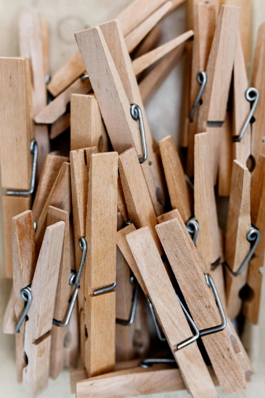 a pile of clothes pegs sitting on top of a table, by Jesper Knudsen, up close, brown, multiple stories, made of wood