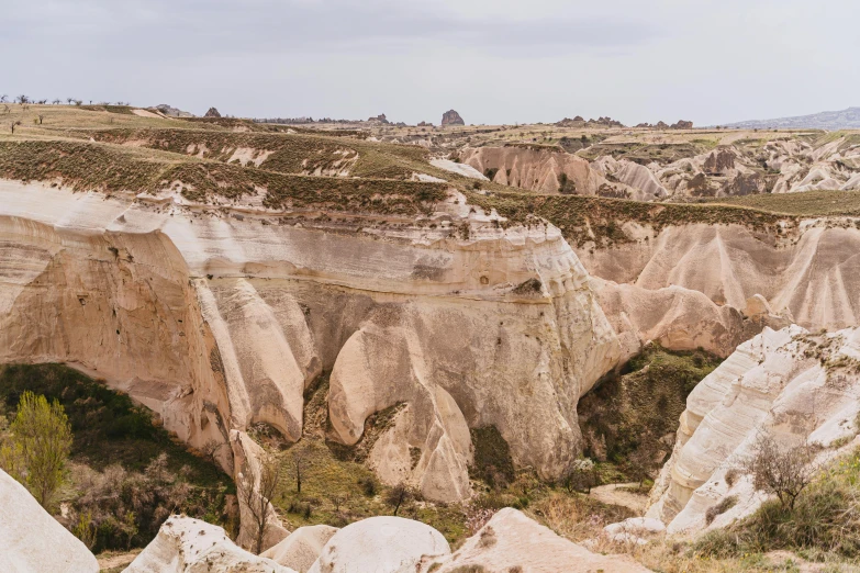 a man riding on the back of a motorcycle down a dirt road, a matte painting, pexels contest winner, art nouveau, white travertine terraces, turkey, cave like teeth, youtube thumbnail