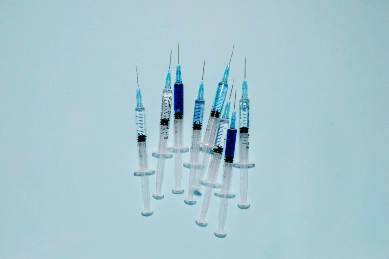 a group of sylls sitting on top of each other, by Gavin Hamilton, pexels, visual art, holding a syringe, blue tinted, steroid use, flies