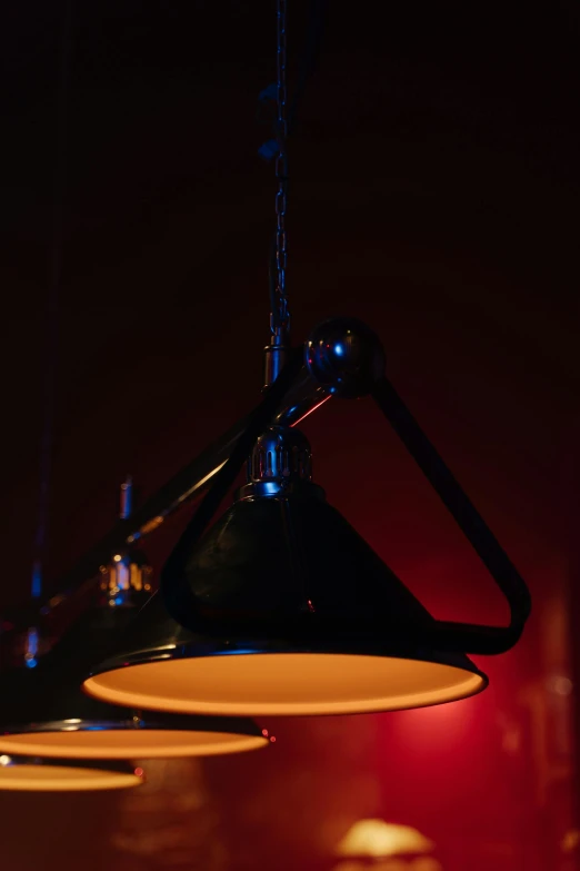 a couple of lights hanging from a ceiling, a portrait, by Nick Fudge, unsplash, product lighting. 4 k, light cone, detail shot, cinematic counter light
