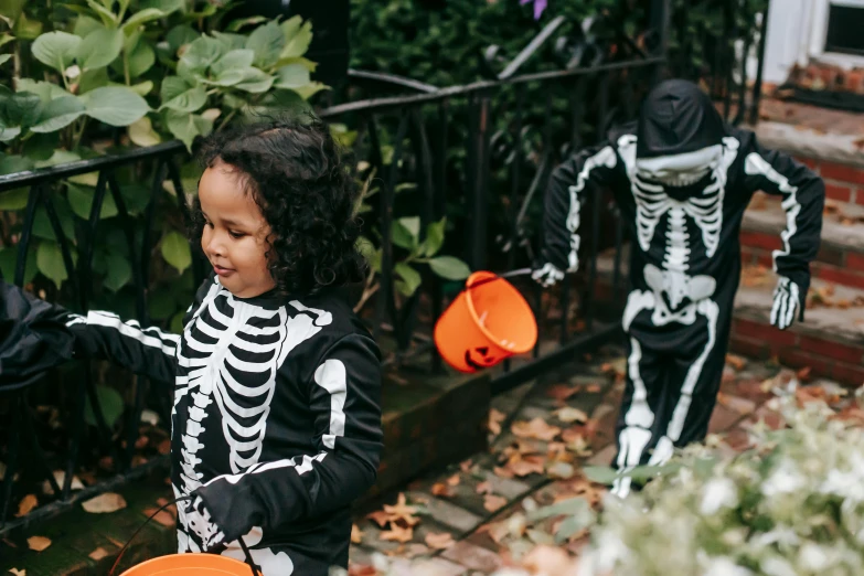 two young children dressed up in halloween costumes, by Helen Stevenson, pexels contest winner, vanitas, walking over a skeleton, gif, gardening, 🦩🪐🐞👩🏻🦳