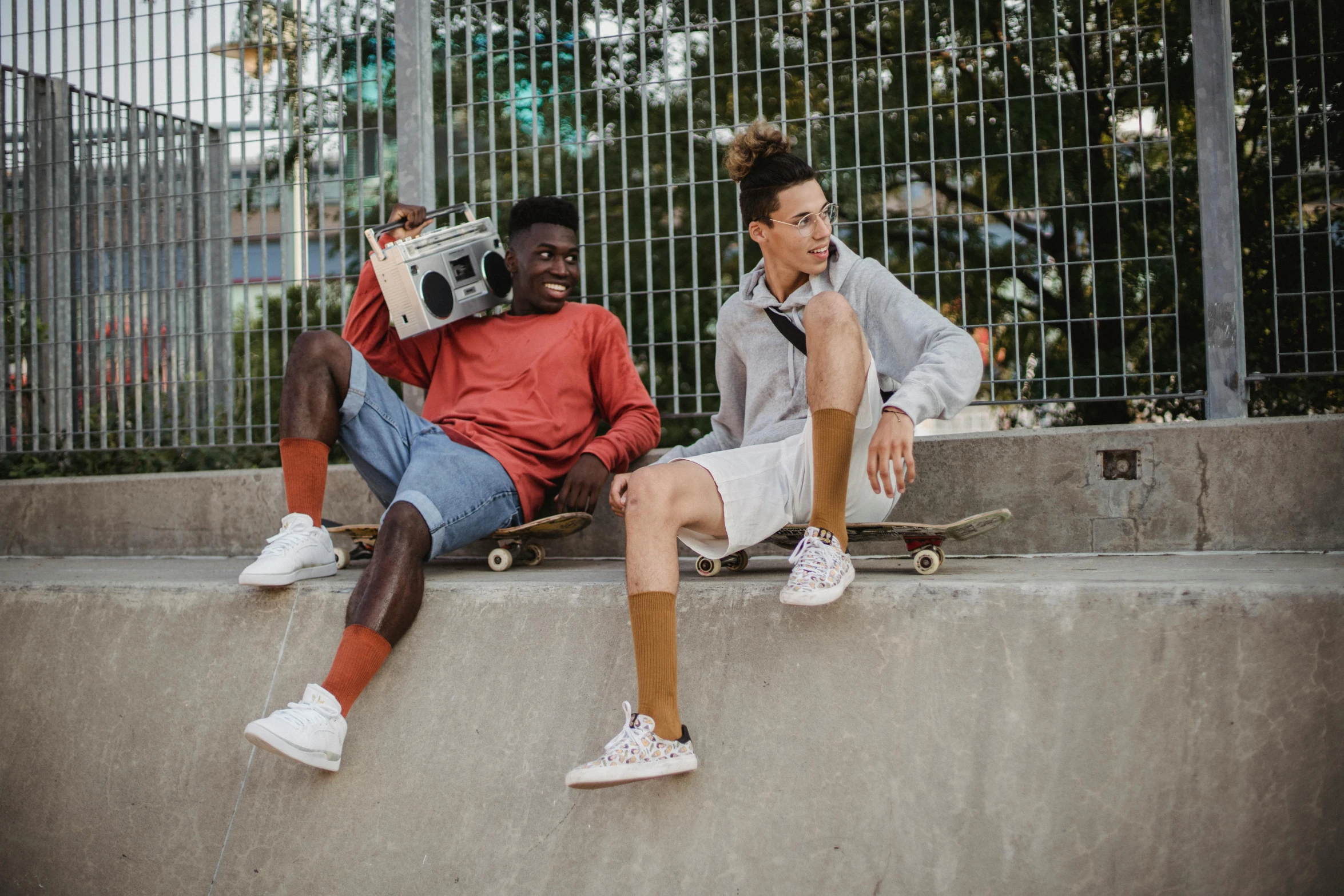 a couple of men sitting next to each other on skateboards, pexels contest winner, happening, bra and shorts streetwear, brown, coloured, 15081959 21121991 01012000 4k