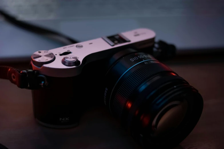 a camera sitting on top of a wooden table, a picture, by Niko Henrichon, unsplash, soft lighting and focus, sony a7, anime style mixed with fujifilm, silver nitrate photography