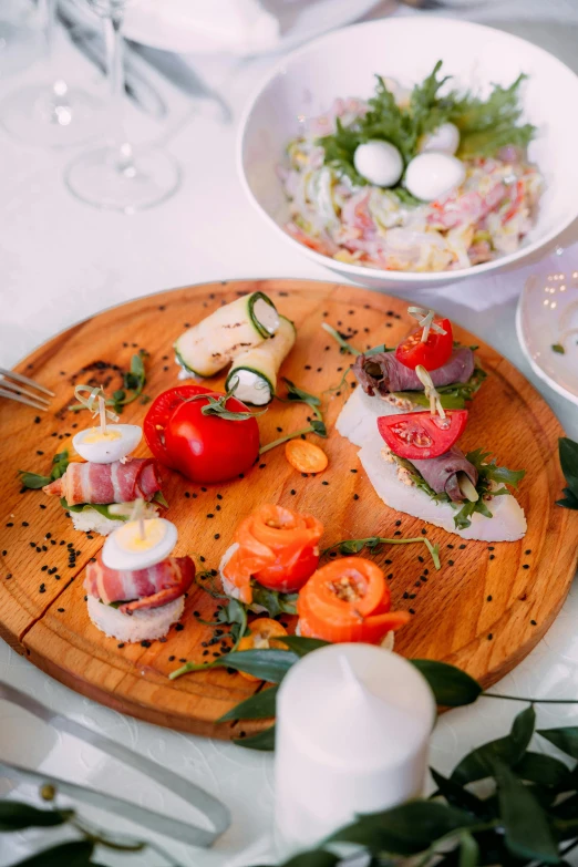 a close up of a plate of food on a table, by Niko Henrichon, on a wooden tray, salad and white colors in scheme, resort, mozzarella